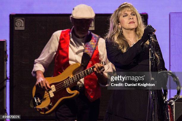 Vocalist Stevie Nicks and bassist John McVie of Fleetwood Mac perform on stage at Viejas Arena on December 2, 2014 in San Diego, California.