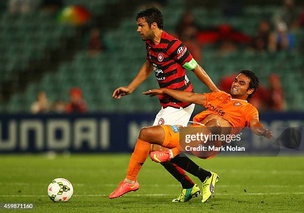 Nikolai Topor-Stanley of the Wanderers and Jean Carlos Solorzano of the Roar contest possession during the round four A-League match between the...