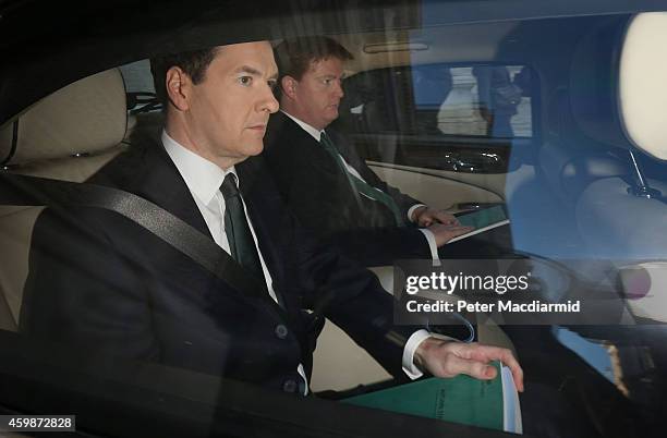 Chancellor George Osborne and Chief Secretary of the Treasury Danny Alexander leave The Treasury for Parliament on December 3, 2014 in London,...