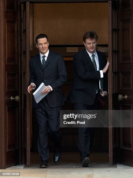 Chancellor George Osborne and Chief Secretary of the Treasury Danny Alexander leave The Treasury for Parliament on December 3, 2014 in London,...