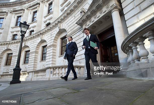 Chancellor George Osborne and Chief Secretary of the Treasury Danny Alexander leave The Treasury for Parliament on December 3, 2014 in London,...