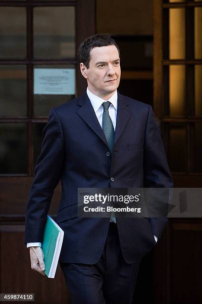 George Osborne, U.K. Chancellor of the exchequer, carries a copy of his Autumn budget statement as he leaves the HM Treasury building before heading...
