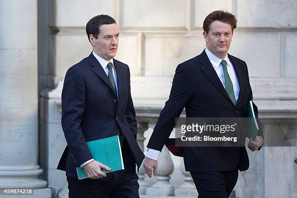 George Osborne, U.K. Chancellor of the exchequer, left, and Danny Alexander, U.K. Chief secretary to the treasury, carry copies of the Autumn budget...