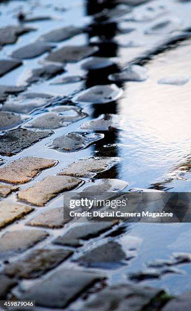 Puddles reflecting morning light on the cobbled street, taken on October 9, 2008.