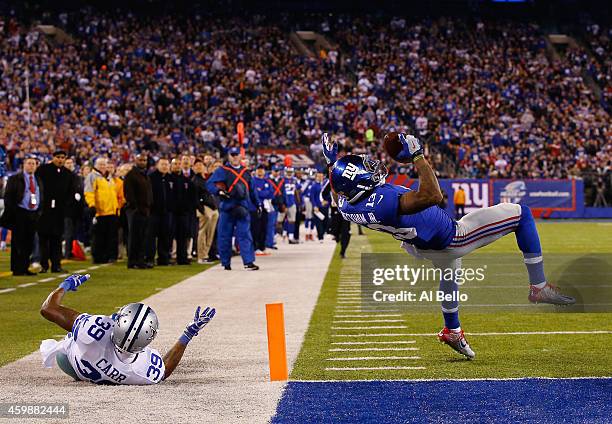 Odell Beckham of the New York Giants scores a touchdown in the second quarter against Brandon Carr of the Dallas Cowboys at MetLife Stadium on...