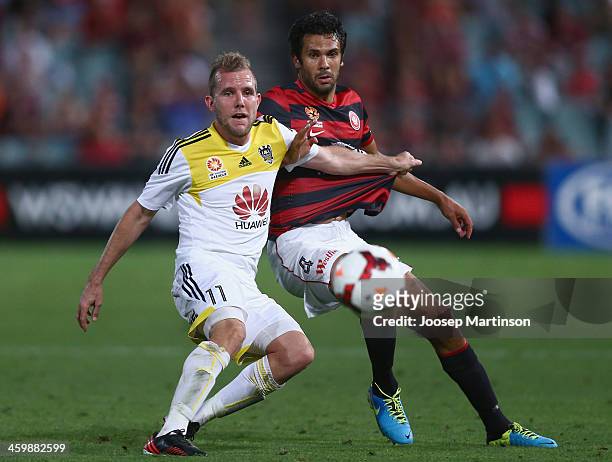 Nikolai Topor-Stanley of the Wanderers competes with Jeremy Brockie of the Phoenix during the round 13 A-League match between the Western Sydney...