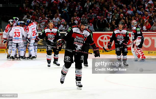 John Tripp of Koelner Haie looks dejected during the DEL Ice Hockey match between Koelner Haie and Eisbaeren Berlin at Lanxess Arena on December 3,...