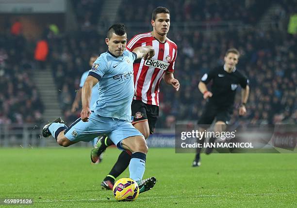 Manchester City's Argentinian striker Sergio Aguero shoots to score their first goal during the English Premier League football match between...