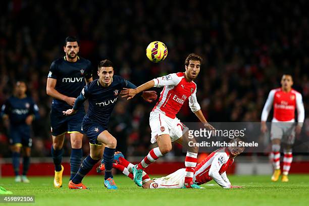 Dusan Tadic of Southampton battles for the ball with Mathieu Flamini and Laurent Koscielny of Arsenal during the Barclays Premier League match...