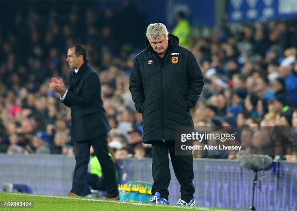 Steve Bruce the manager of Hull City reacts after his team concede the opening goal during the Barclays Premier League match between Everton and Hull...