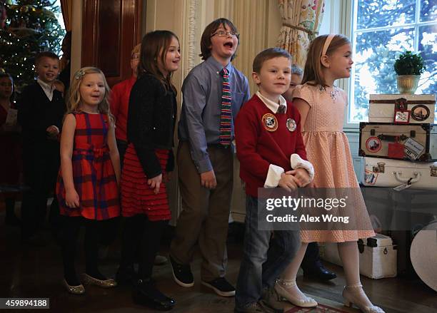 Military children react as they enter the State Dining Room of the White House for an event with U.S. First lady Michelle Obama December 3, 2014 in...