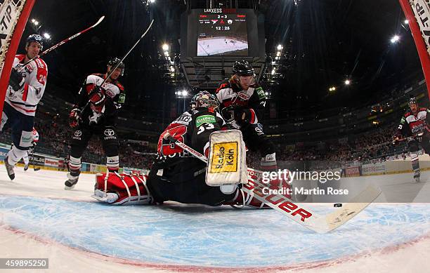 Danny aus den Birken , goaltender of Koelner Haie makes a save on Andre Rankel of Eisbaeren Berlin during the DEL Ice Hockey match between Koelner...