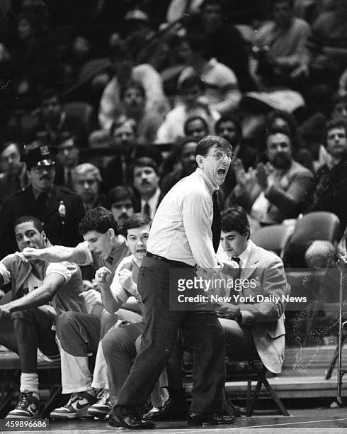 Lou Carnesecca, St. John's head basketball coach and head cheerleader, gives it the old college try on sidelines of Madison Square Garden as his...