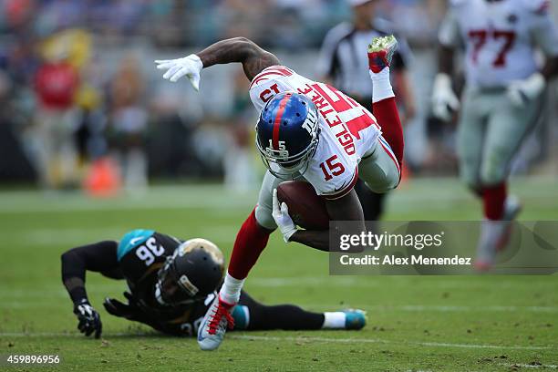 Wide receiver Kevin Ogletree of the New York Giants gets tripped up by safety Sherrod Martin of the Jacksonville Jaguars during an NFL football game...