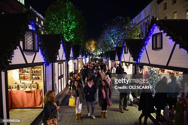 Members of the public shopping in the 'St Nicholas Fair' Christmas market in the city centre of York, Northern England on December 3, 2014. AFP PHOTO...