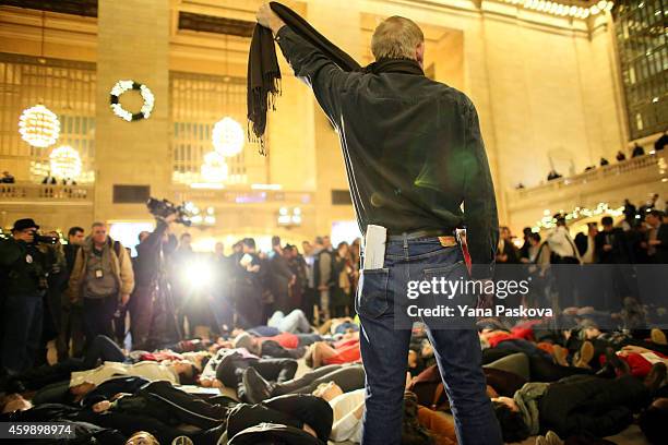 Man symbolically chokes himself with a scarf during a protest in Grand Central Terminal December 3, 2014 in New York. Protests began after a Grand...