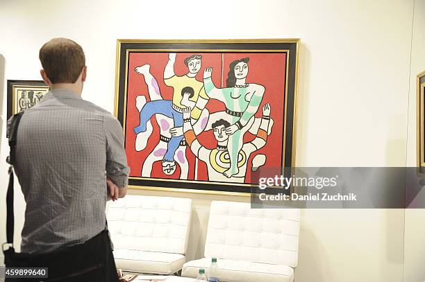 Attendees view art from Hammer Galleries during Art Basel Miami Beach 2014 - VIP Preview at the Miami Beach Convention Center on December 3, 2014 in...