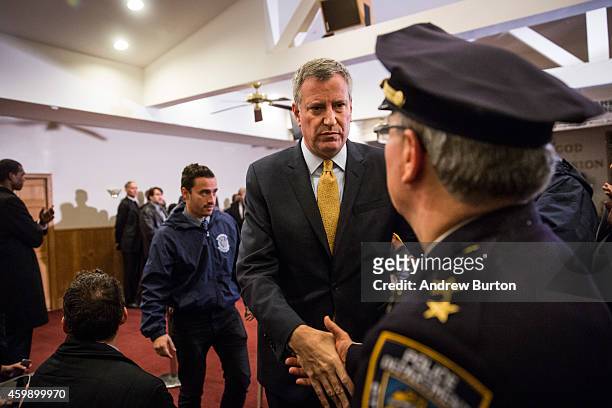 New York City Mayor Bill de Blasio shakes hands with New York Police Department Borough Commander for Staten Island Edward Delatorre after speaking...
