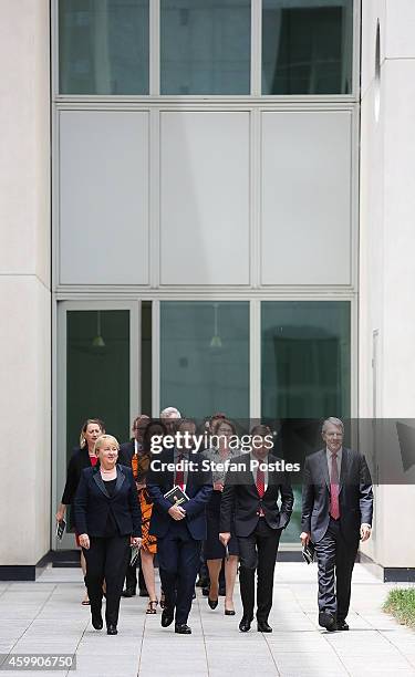 Opposition leader Bill Shorten and his colleagues arrive at a press conference to reflect on 'Tony Abbott's Year of Broken Promises' at Parliament...