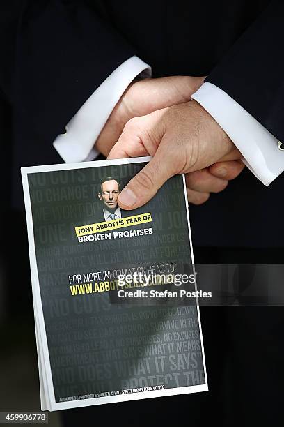 Tony Abbott's Year of Broken Promises' book held during an opposition press conference at Parliament House on December 4, 2014 in Canberra,...