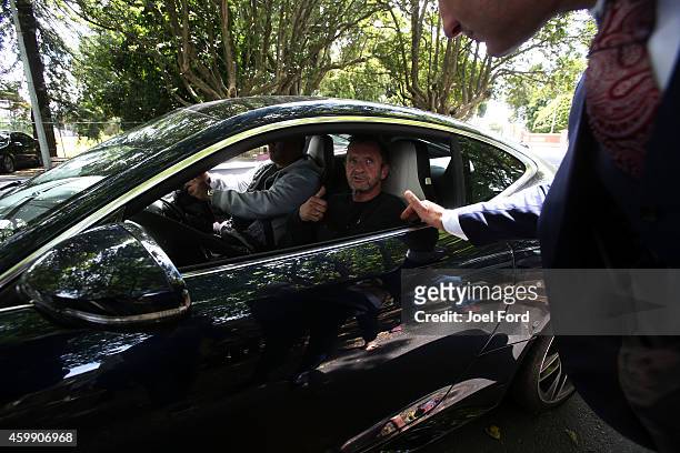 Drummer Phil Rudd gives thumbs up to lawyer Craig Tuck as he leaves Tauranga District Court after being arrested in relation to breach of bail...