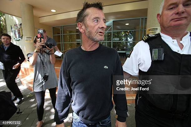 Drummer Phil Rudd leaves Tauranga District Court after being arrested in relation to breach of bail conditions on December 4, 2014 in Tauranga, New...