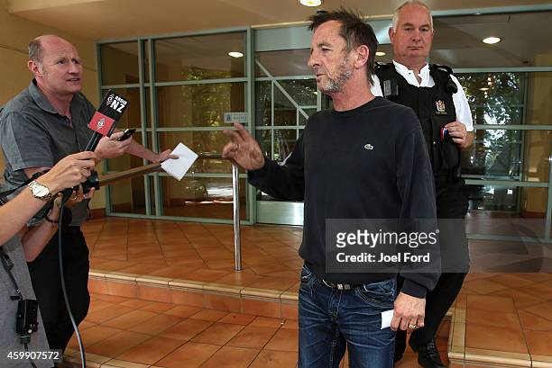 Drummer Phil Rudd speaks to reporters as he leaves Tauranga District Court after being arrested in relation to breach of bail conditions on December...