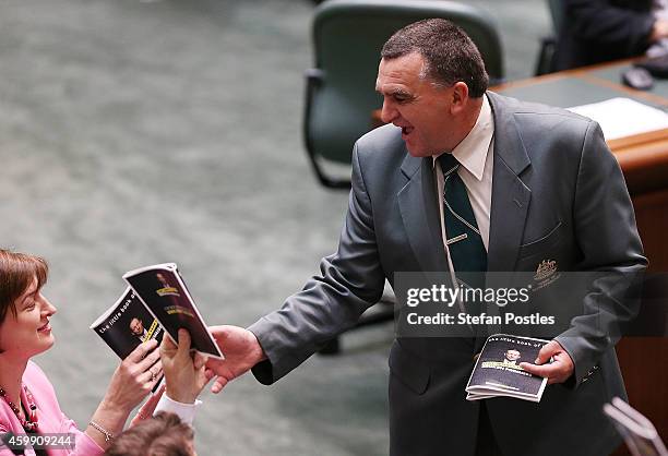 Members of the opposition hand in their props 'Tony Abbott's year of broken promises' during House of Representatives question time at Parliament...