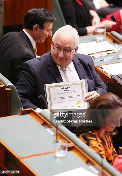 Member for Melbourne Ports Michael Danby holds up a certificate for being the 250th Member ejected by Speaker Bronwyn Bishop at Parliament House on...