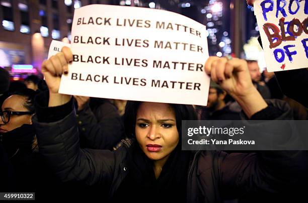 Demonstrators walk together during a protest December 3, 2014 in New York. Protests began after a Grand Jury decided to not indict officer Daniel...