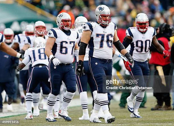 Guard Josh Kline and tackle Sebastian Vollmer of the New England Patriots during the NFL game against the Green Bay Packers at Lambeau Field on...