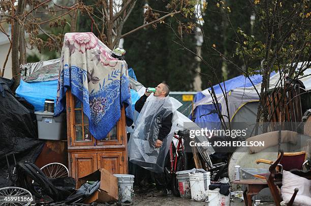 With AFP Story by Veronique DUPONT: US-Poverty-Homeless-Technology A man who only goes by the name David gulps down a drink at the Silicon Valley...