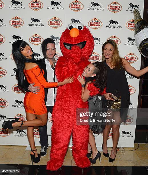 Model Nathalia Henao and guitarist Dj Ashba and guests arrive at the New Year's Eve 2014 celebration at Beacher's Madhouse Las Vegas at the MGM Grand...