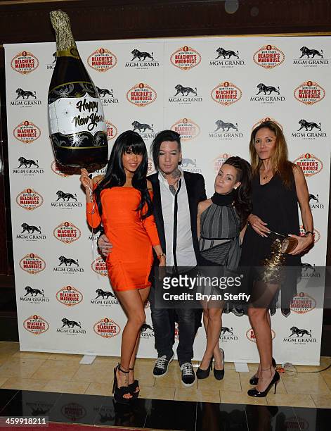 Model Nathalia Henao and guitarist Dj Ashba and guests arrive at the New Year's Eve 2014 celebration at Beacher's Madhouse Las Vegas at the MGM Grand...