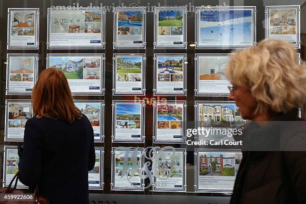 Woman views adverts in the window of an estate agents on December 4, 2014 in in East Dulwich, London, England. In his autumn statement, Chancellor of...