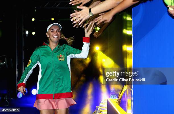 Caroline Wozniacki of the UAE Royals high fives the fans as she runs out for her teams match against the Singapore Slammers during the Coca-Cola...