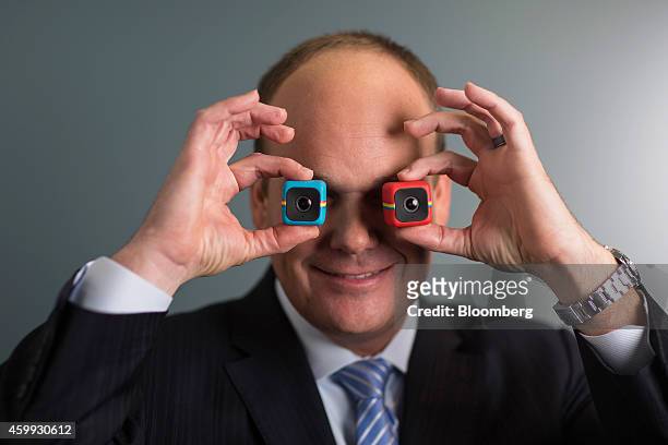 Scott Hardy, chief executive officer of Polaroid, holds the company's latest Cube digital cameras as he poses for a photograph following a Bloomberg...