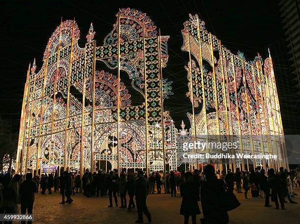 People admire the Luminarie illuminations as a part of the 20th Kobe Luminarie on December 4, 2014 in Kobe, Japan. This year, Kobe Luminarie will be...