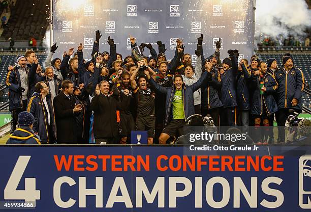 Robbie Keane of the Los Angeles Galaxy hoists the Western Conference trophy after the Galaxy advanced to the MLS cup against the Seattle Sounders FC...