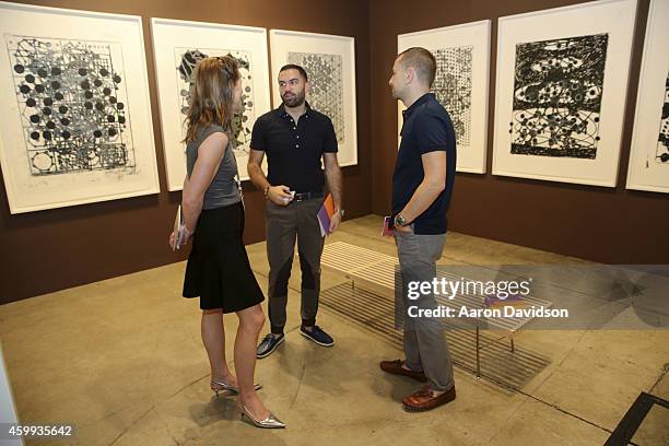 Attendees view art at the Two Palms gallery during the Art Basel Miami Beach 2014 - VIP Preview at the Miami Beach Convention Center on December 3,...