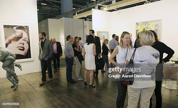 Attendees view art at the Skarstedt booth during Art Basel Miami Beach 2014 - VIP Preview at the Miami Beach Convention Center on December 3, 2014 in...