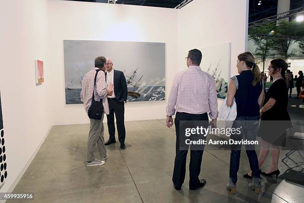 Attendees view art at the Susanne Vielmetter Los Angeles Projects gallery during Art Basel Miami Beach 2014 - VIP Preview at the Miami Beach...