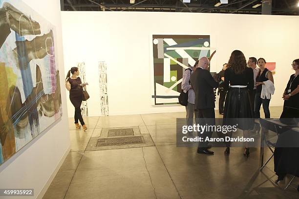 Attendees view art at the Susanne Vielmetter Los Angeles Projects gallery during Art Basel Miami Beach 2014 - VIP Preview at the Miami Beach...