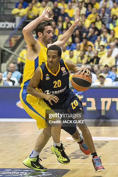 Berlin's American guard Alex Renfroe dribbles past Maccabi Electra Tel Aviv's Israeli forward Jake Cohen during their group B Euroleague basketball...