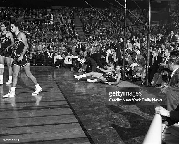 Basketball Duquesne vs Dayton Sihugo Green of Duquesne, grabs loose ball in scramble with 7-foot Bill Uhl of Dayton in NIT finals before 18,496...