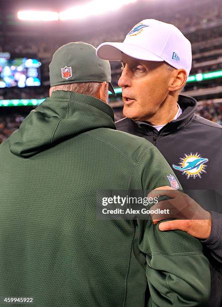 Head coach Joe Philbin of the Miami Dolphins shakes hands with head coach Rex Ryan of the New York Jets after their game at MetLife Stadium on...
