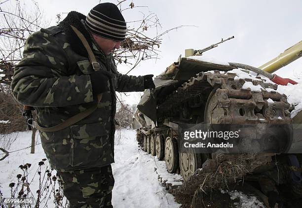 Ukrainian soldier shows the damage at the tank happened during the clashes with pro-Russian separatists who a ceasefire for 71 times in a 24-hour, at...
