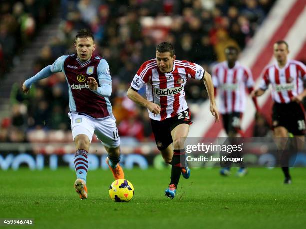 Emanuele Giaccherini of Sunderland is chased by Andreas Weimann of Aston Villa during the Barclays Premier League match between Sunderland and Aston...