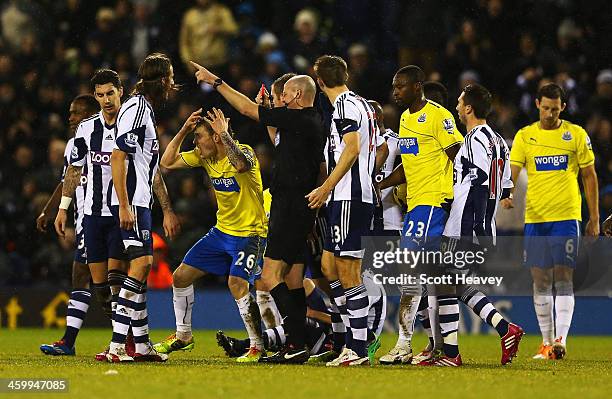Mathieu Debuchy of Newcastle United is shown the red card by referee Lee Mason during the Barclays Premier League match between West Bromwich Albion...