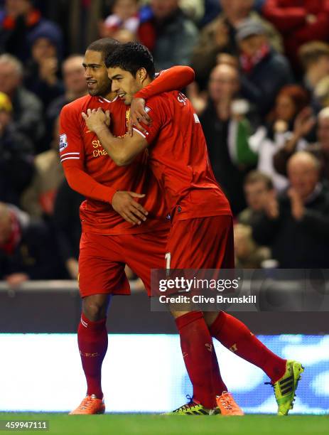 Luis Suarez of Liverpool celebrates scoring their second goal with Glen Johnson of Liverpool during the Barclays Premier League match between...